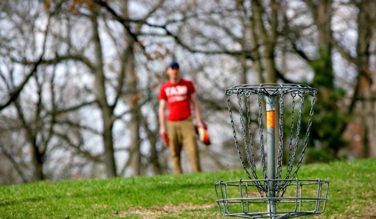 Student playing disc golf