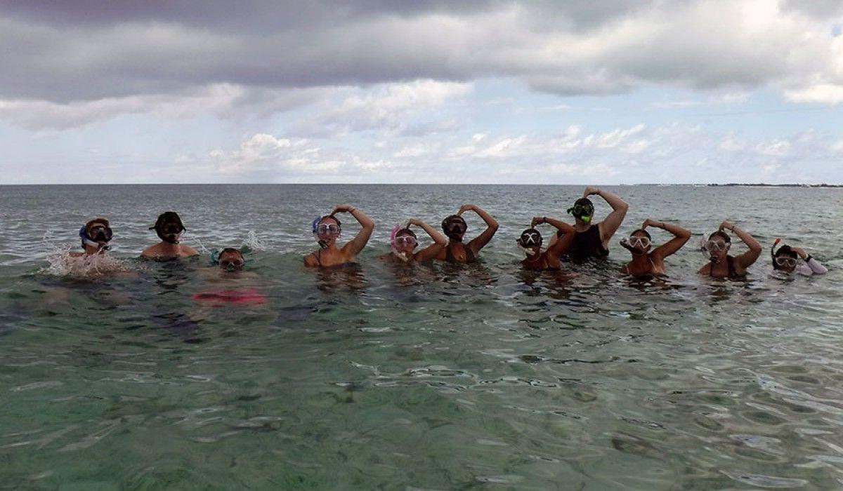 Students give the OK signal before swimming to the wall