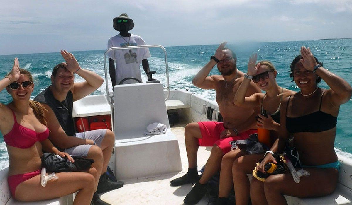 the boat crew giving the shark signal after their snorkel